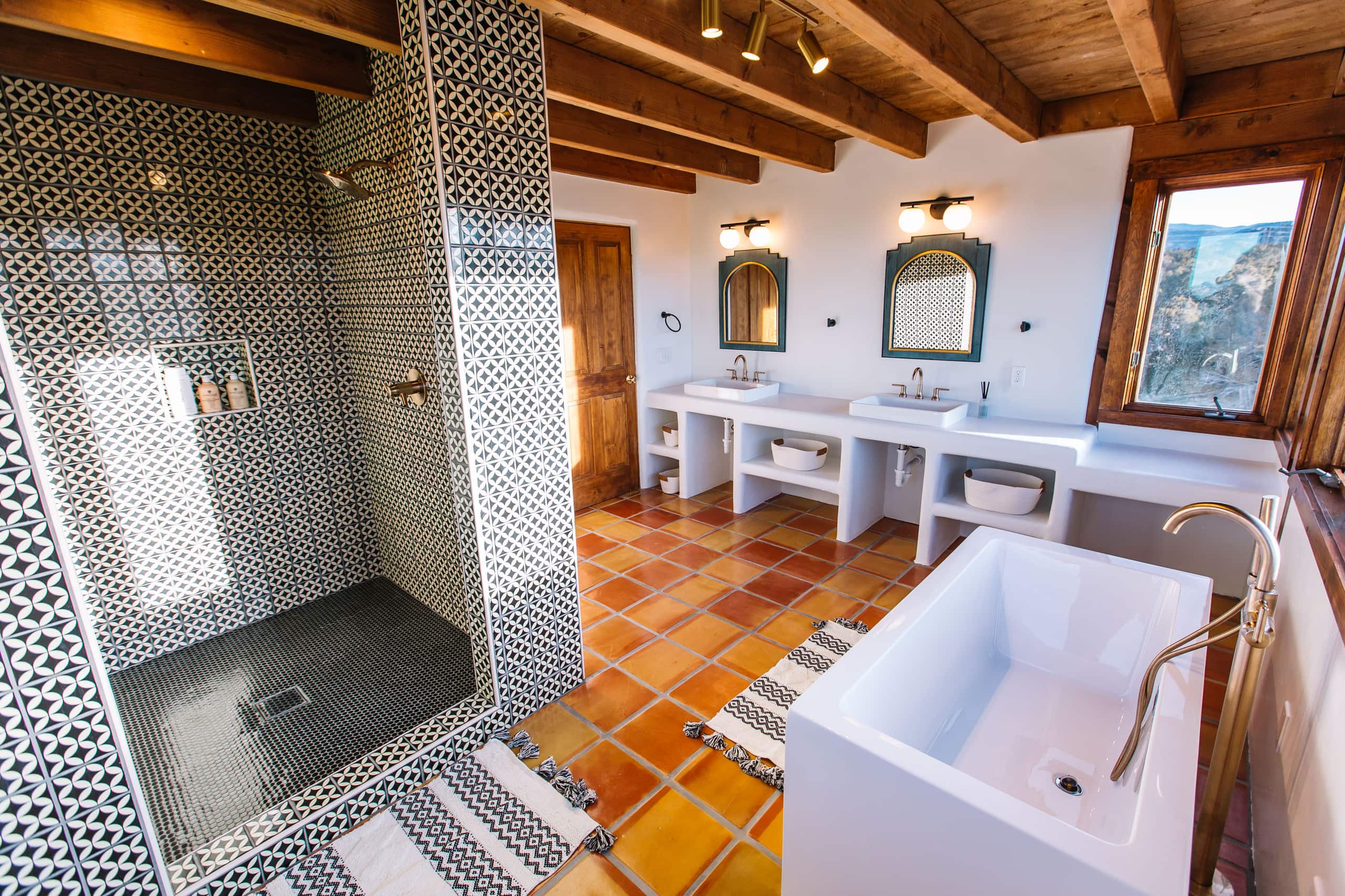 Primary bath with tile shower, freestanding tub, and double vanity