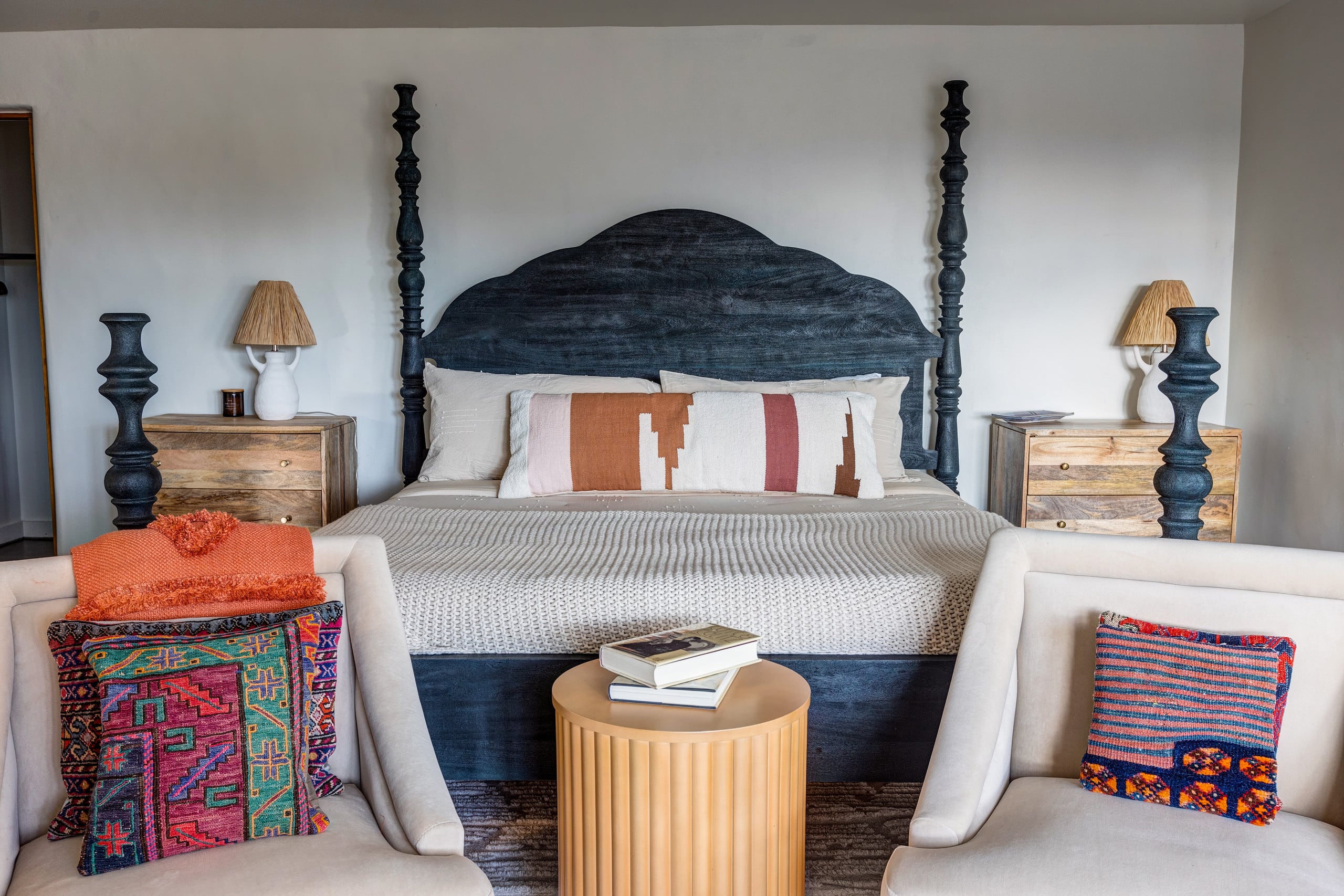 King bedroom with navy hand-carved four-poster bed