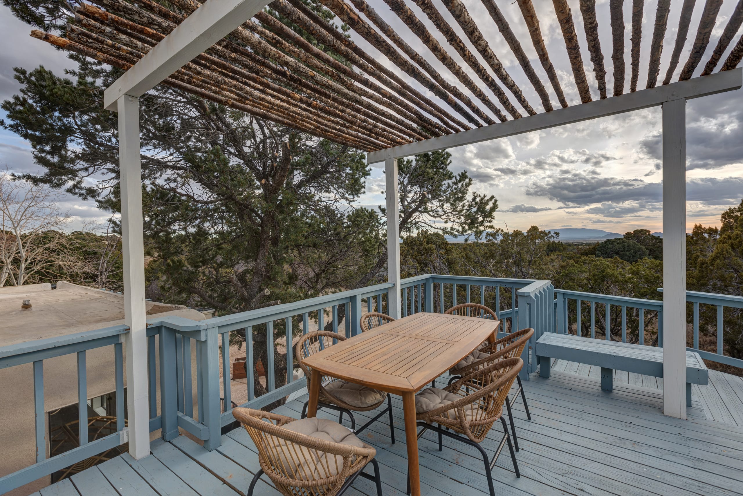 Sunset deck under the latilla pergola with juniper-hill views