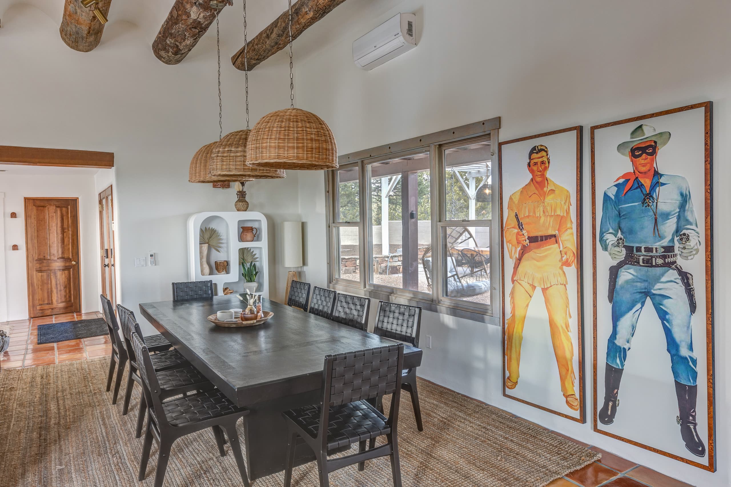 Twelve-person dining table under wicker pendants