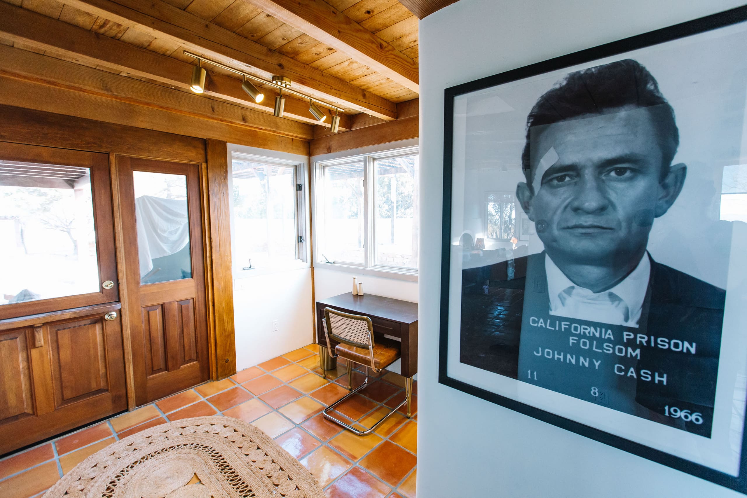 Entry with wood dutch door and Johnny Cash print