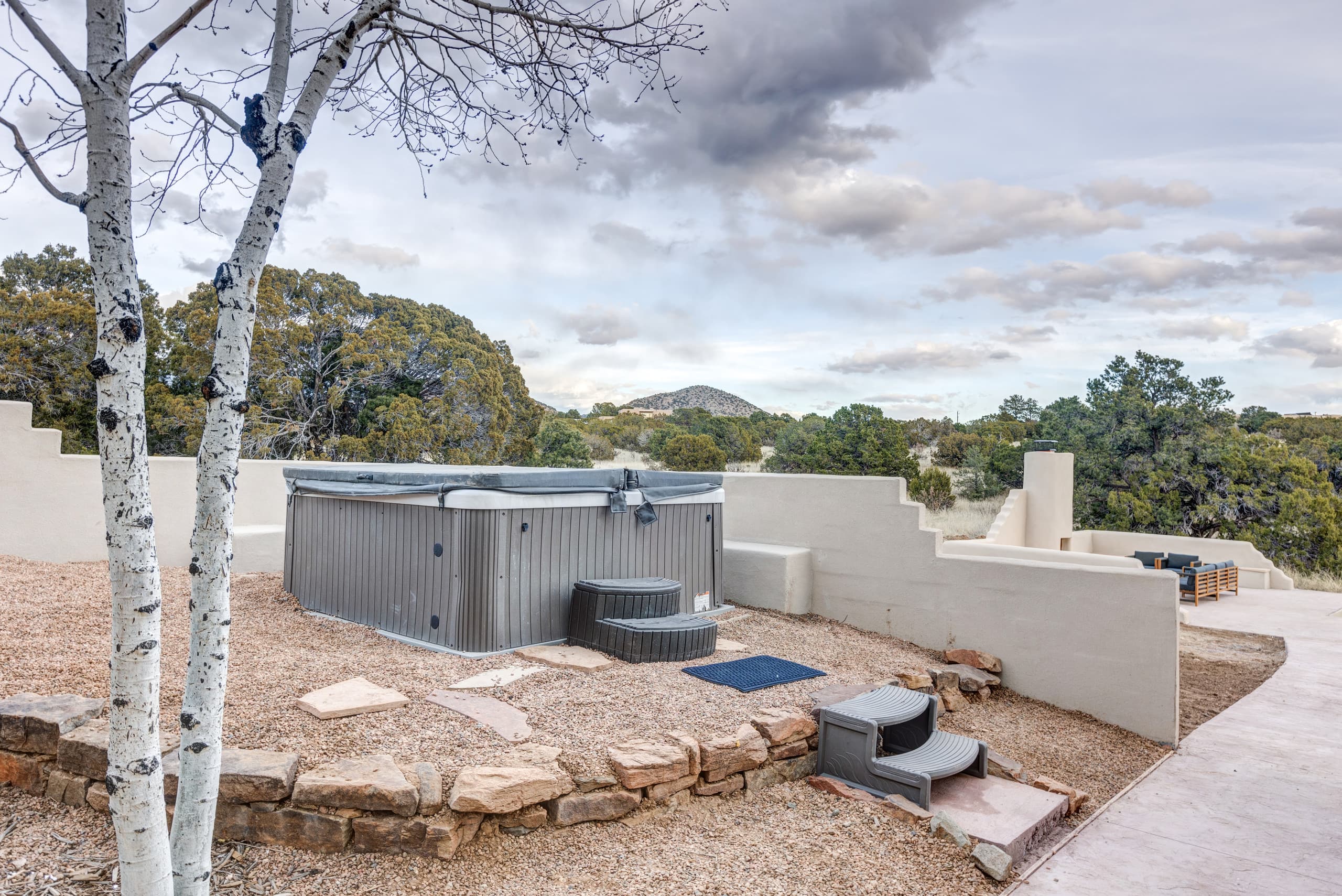 Hot tub tucked behind sculpted stucco walls