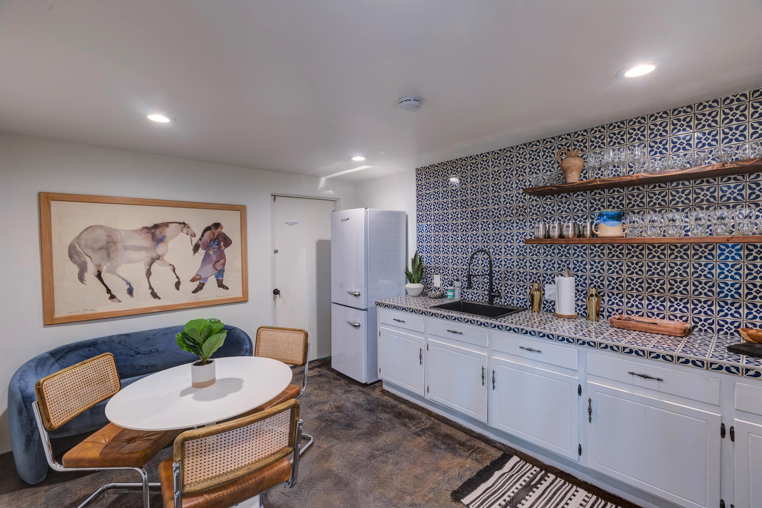 In-law kitchenette with blue Talavera tile and retro fridge