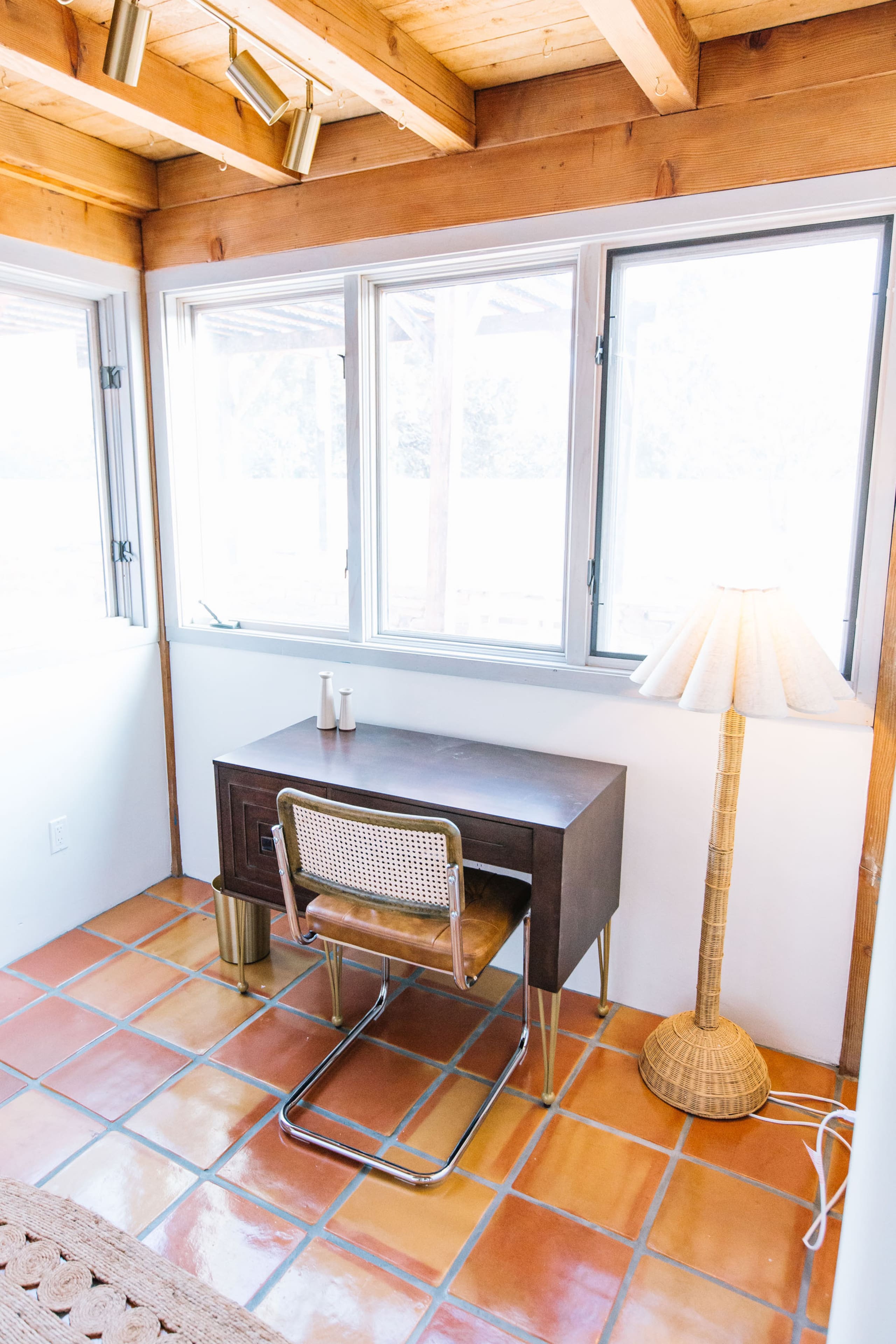 Desk nook with vintage walnut desk and wall of windows