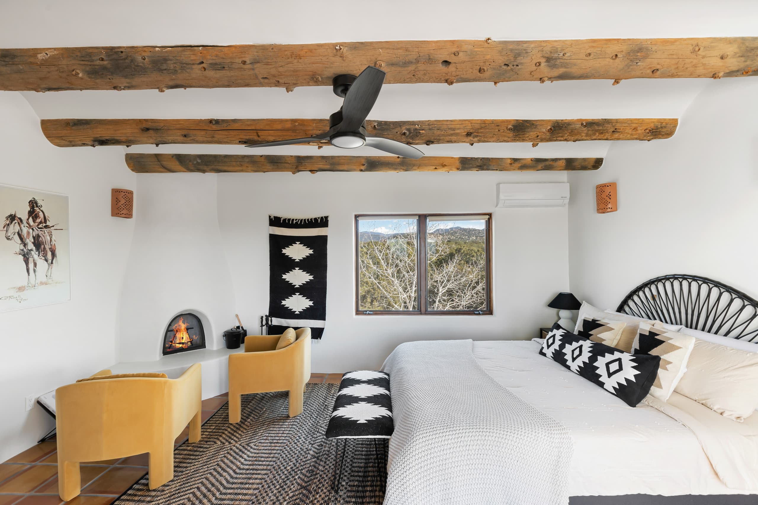 King suite with corner kiva fireplace and mountain-view window