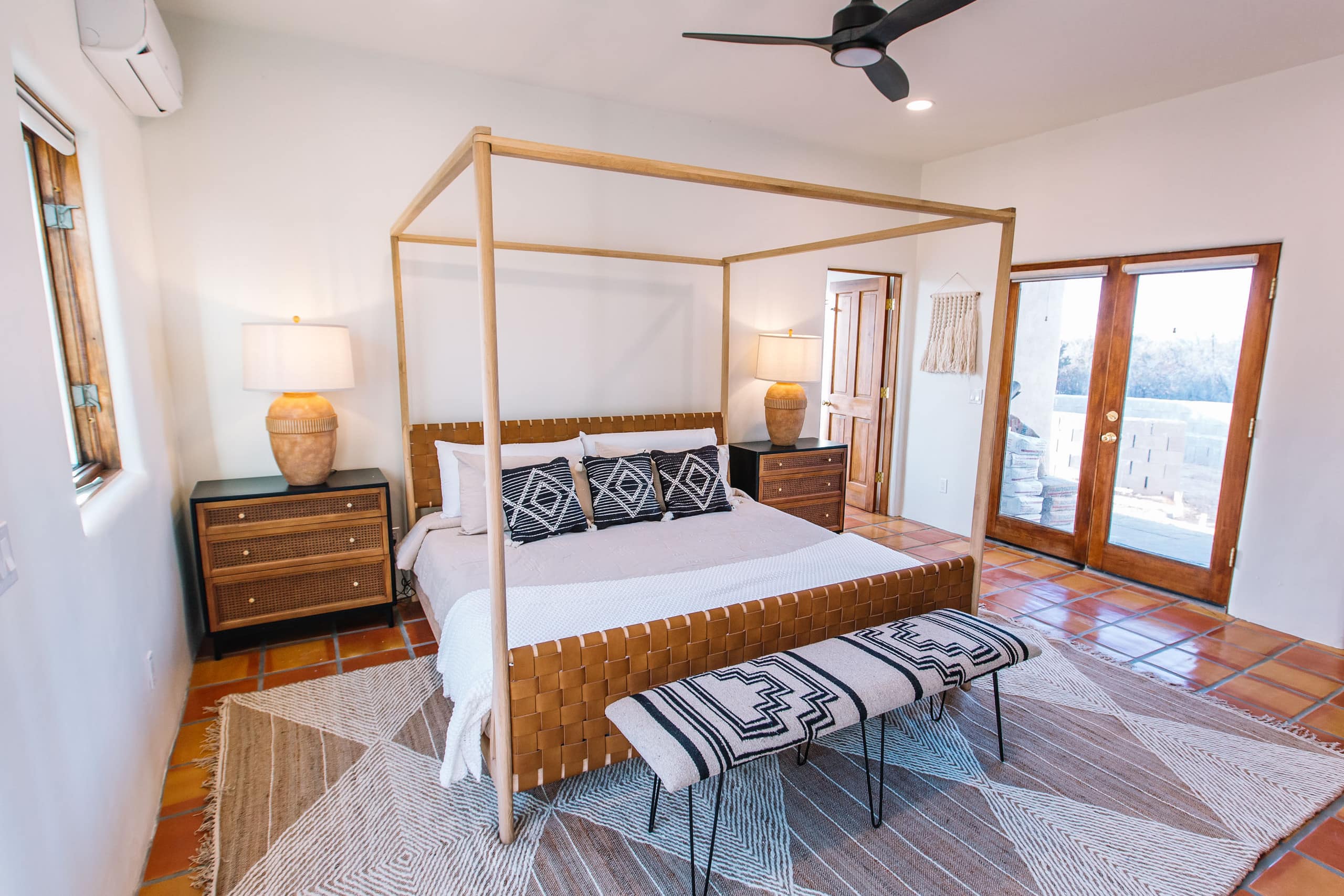 King suite with woven-leather headboard and patio doors