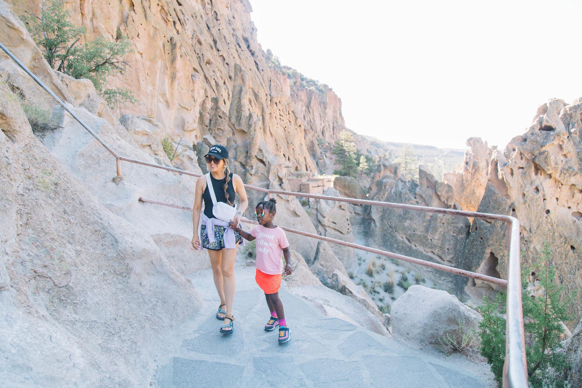 Family descending a walkway into a rocky canyon