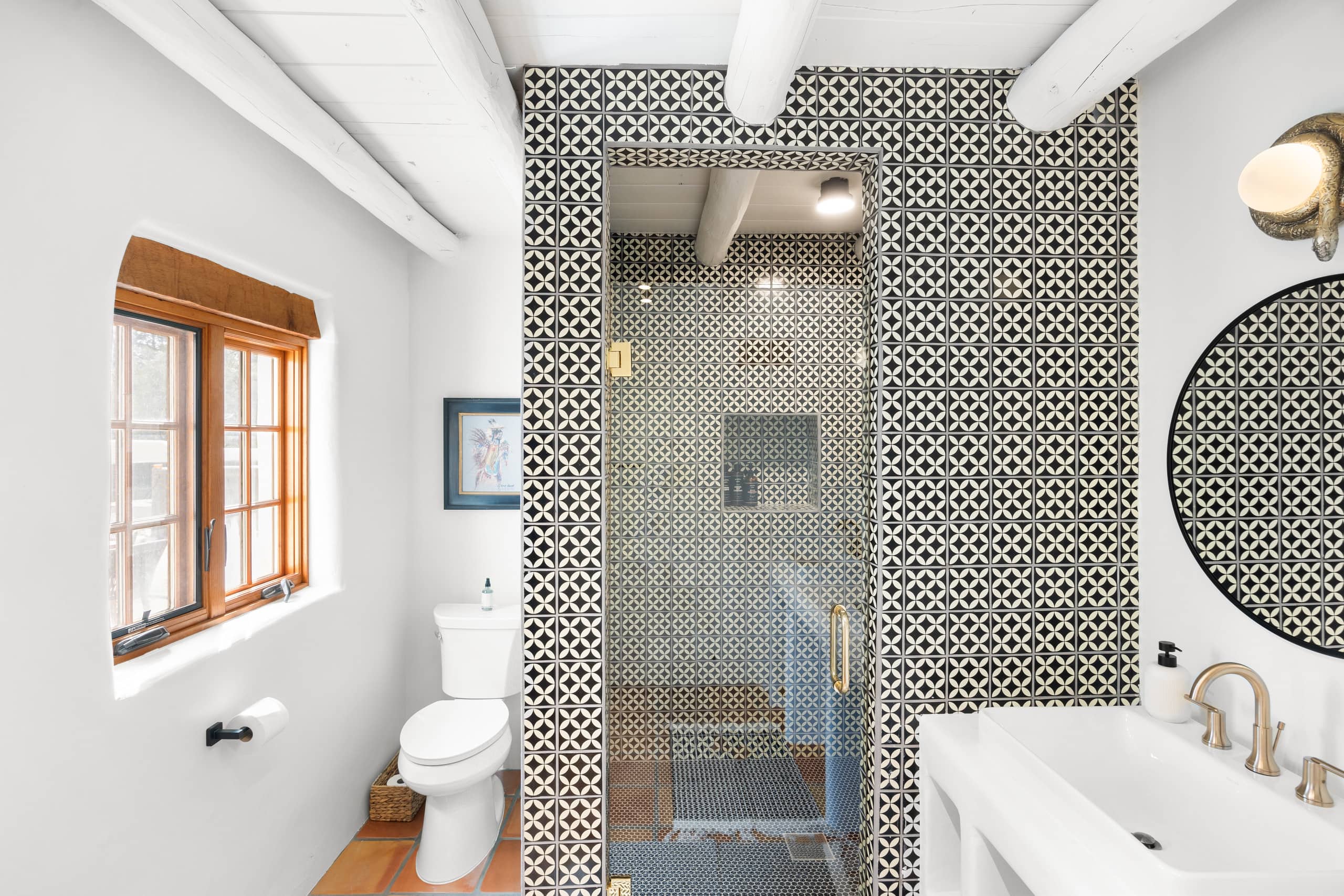 Bath with black-and-white patterned tile shower