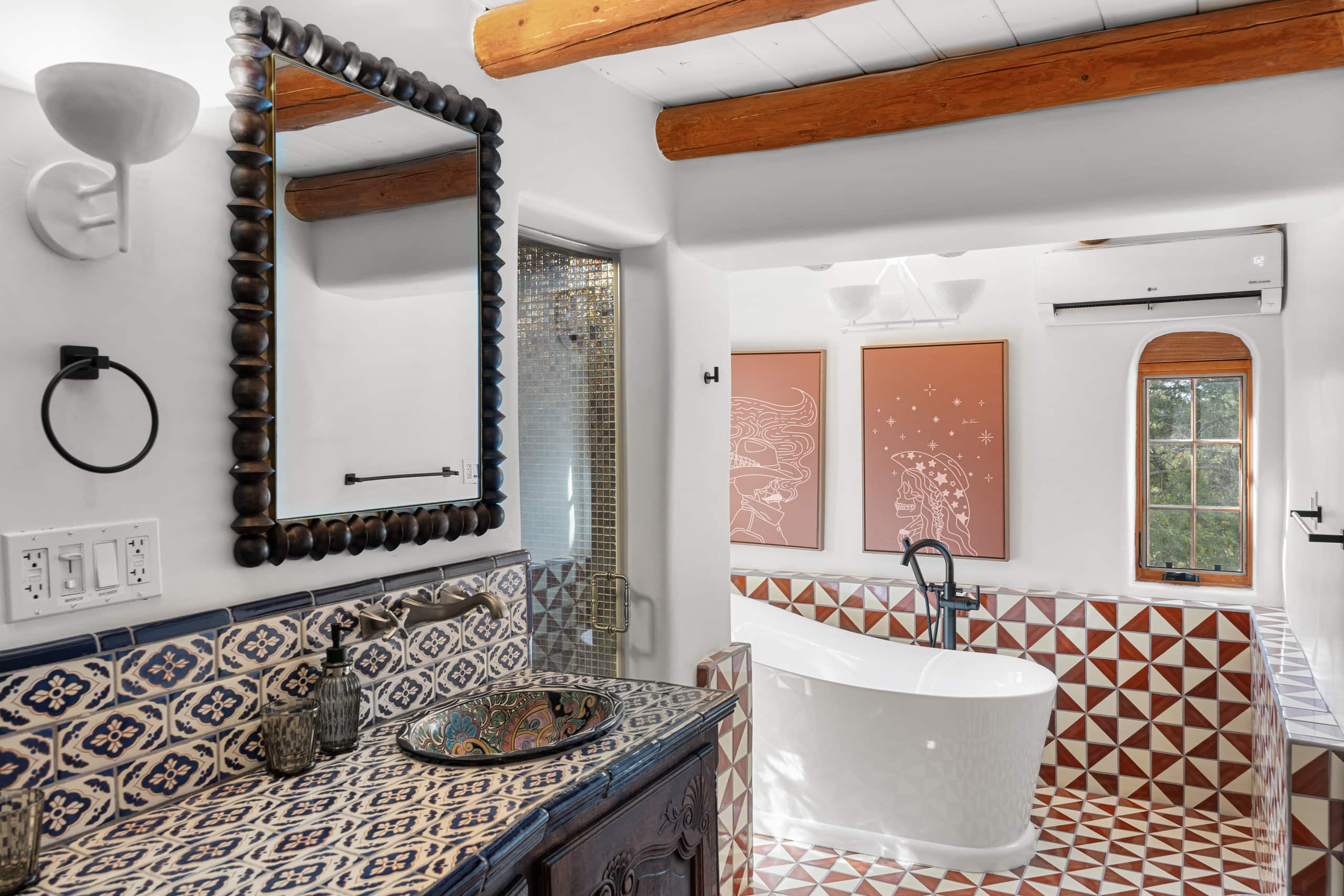 Bath with freestanding tub, beaded mirror, and painted sink