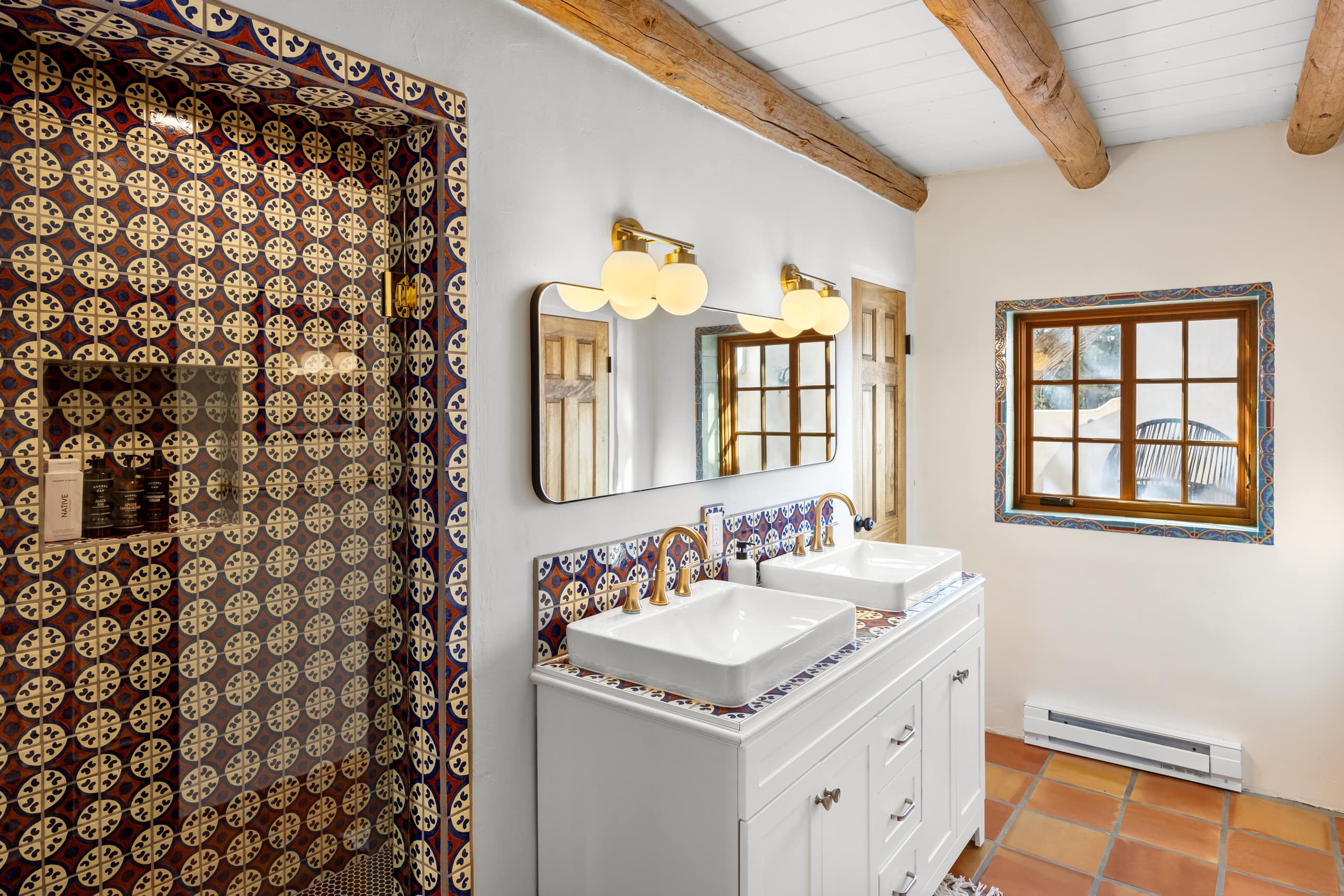 Bath with Talavera medallion-tile shower and blue-tile vanity