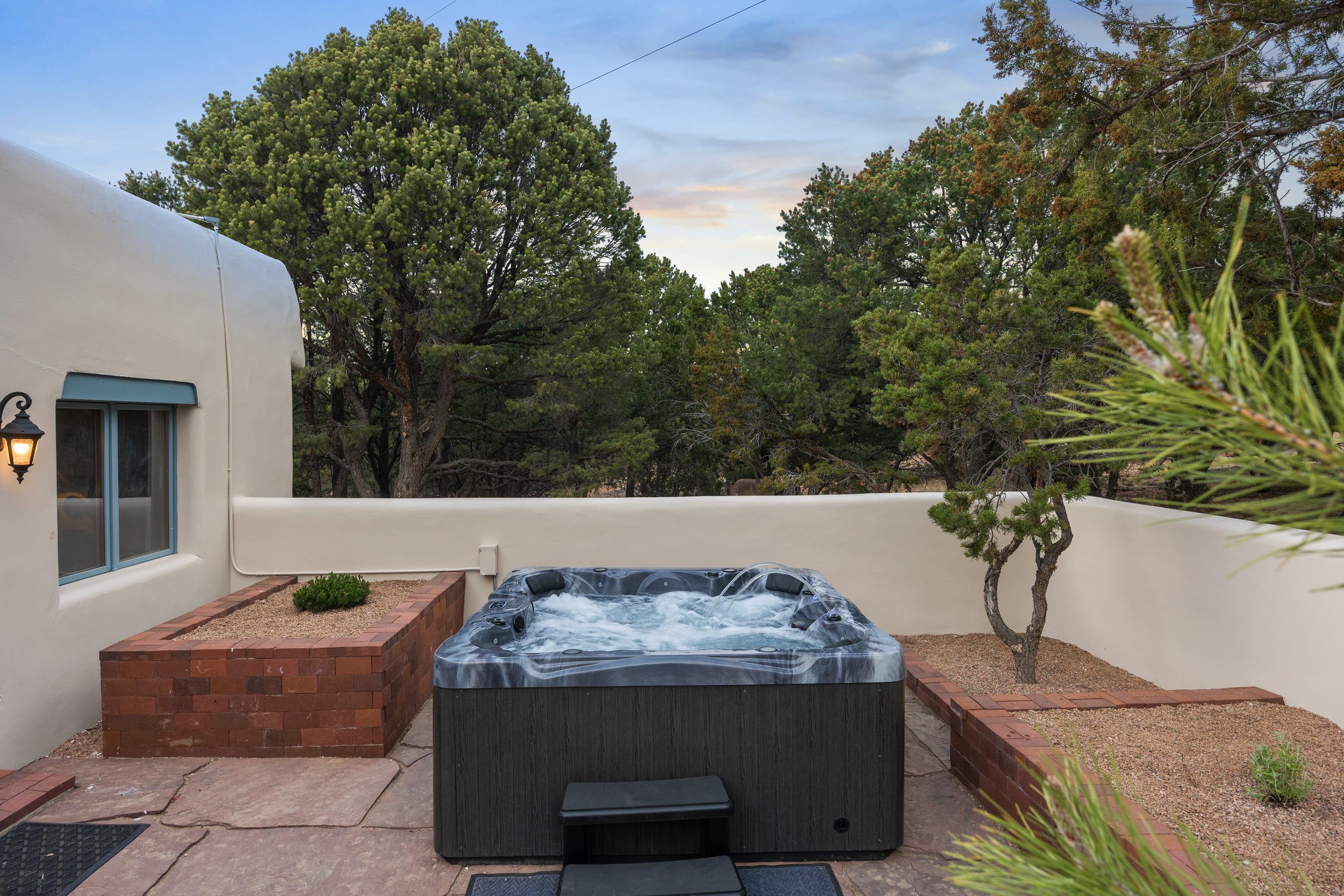 Hot tub bubbling in the walled garden courtyard