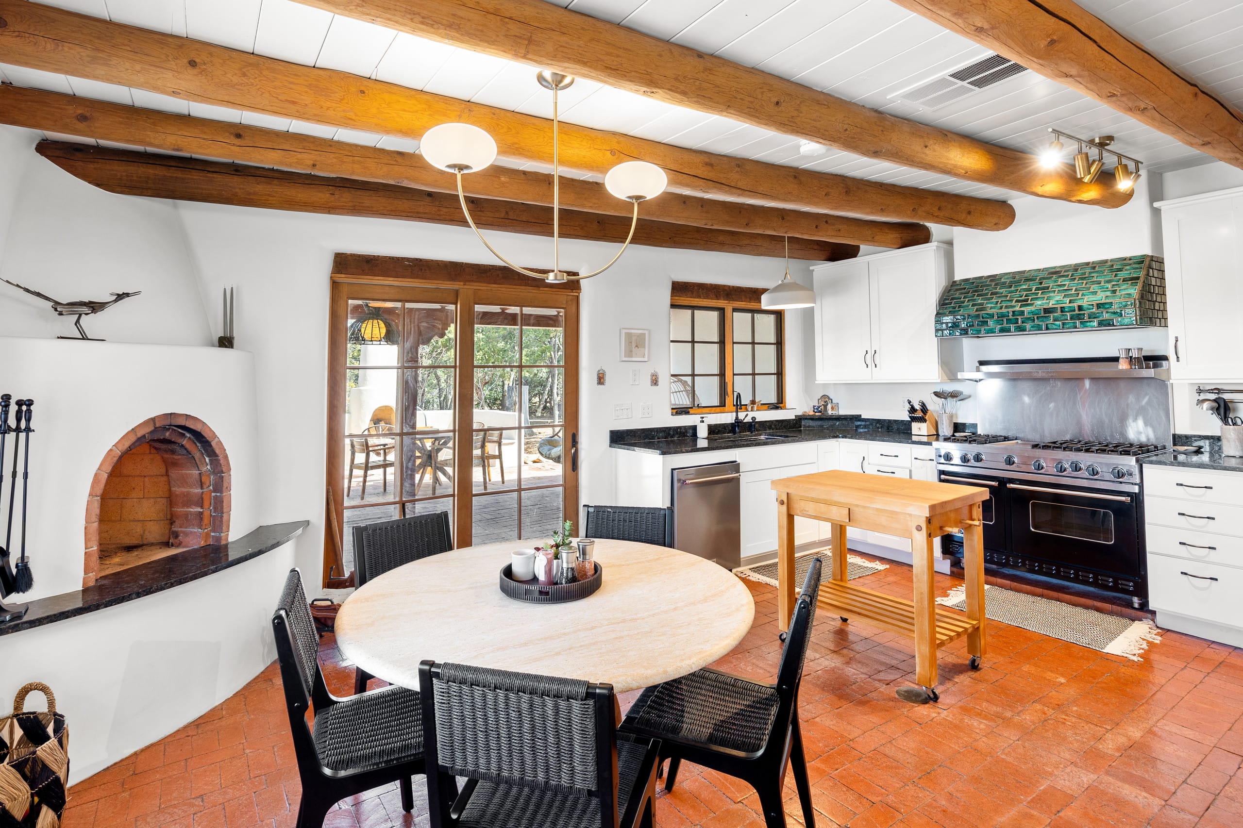 Chef's kitchen with green-tile hood, Viking range, and butcher-block island