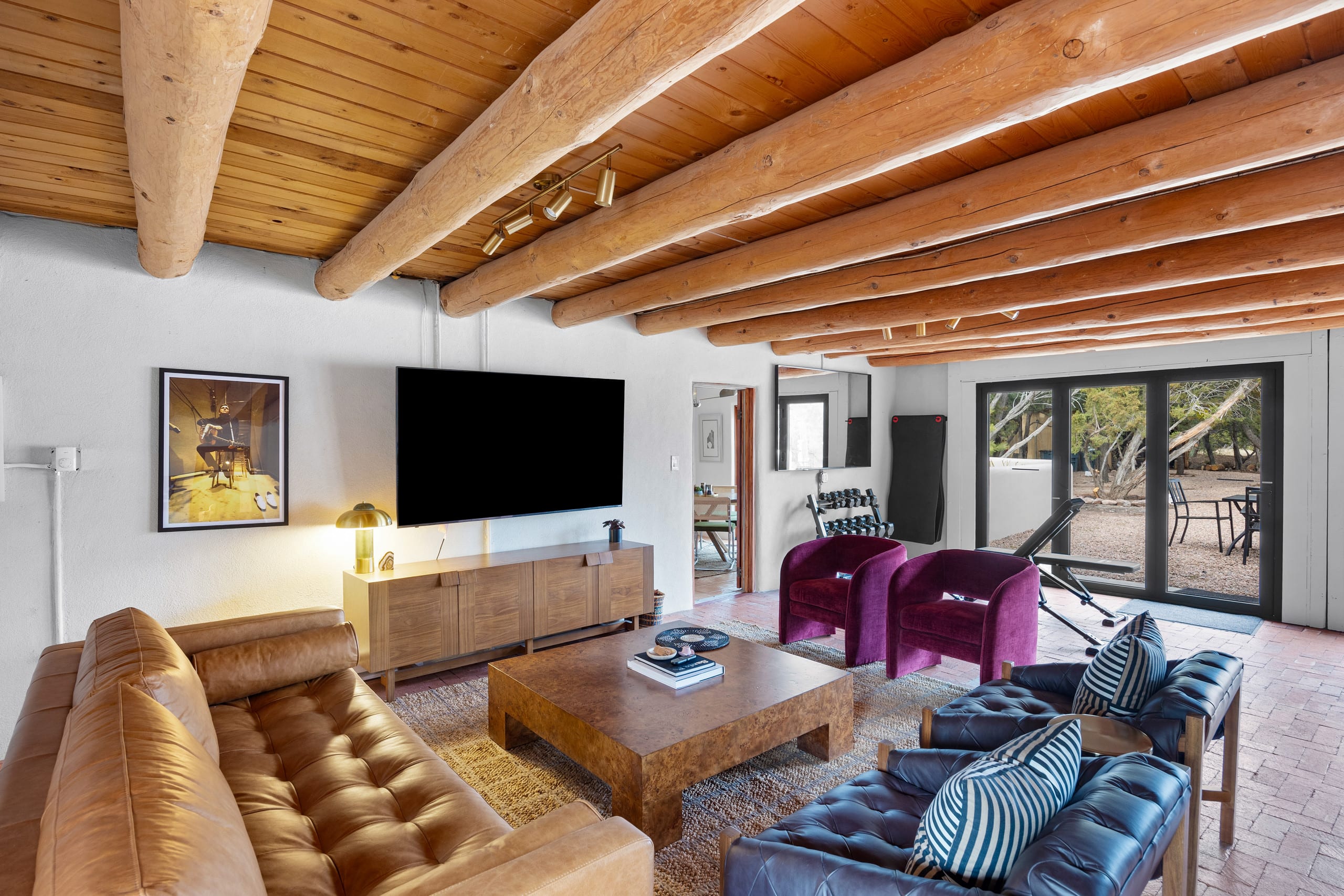 Media lounge with big screen and tufted sofas