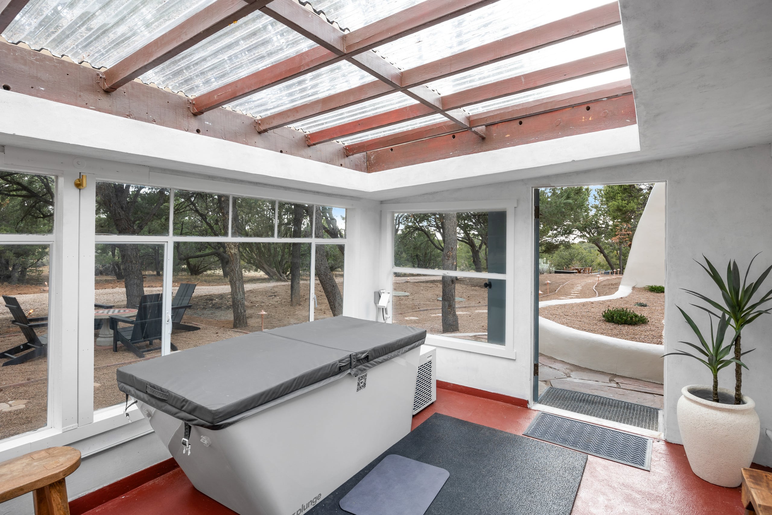 Cold plunge in the sunroom with courtyard door open