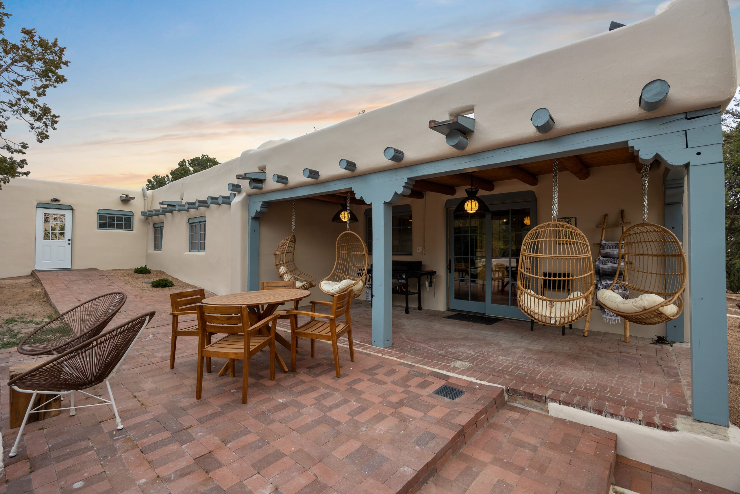 Back portal at dusk with hanging rattan chairs