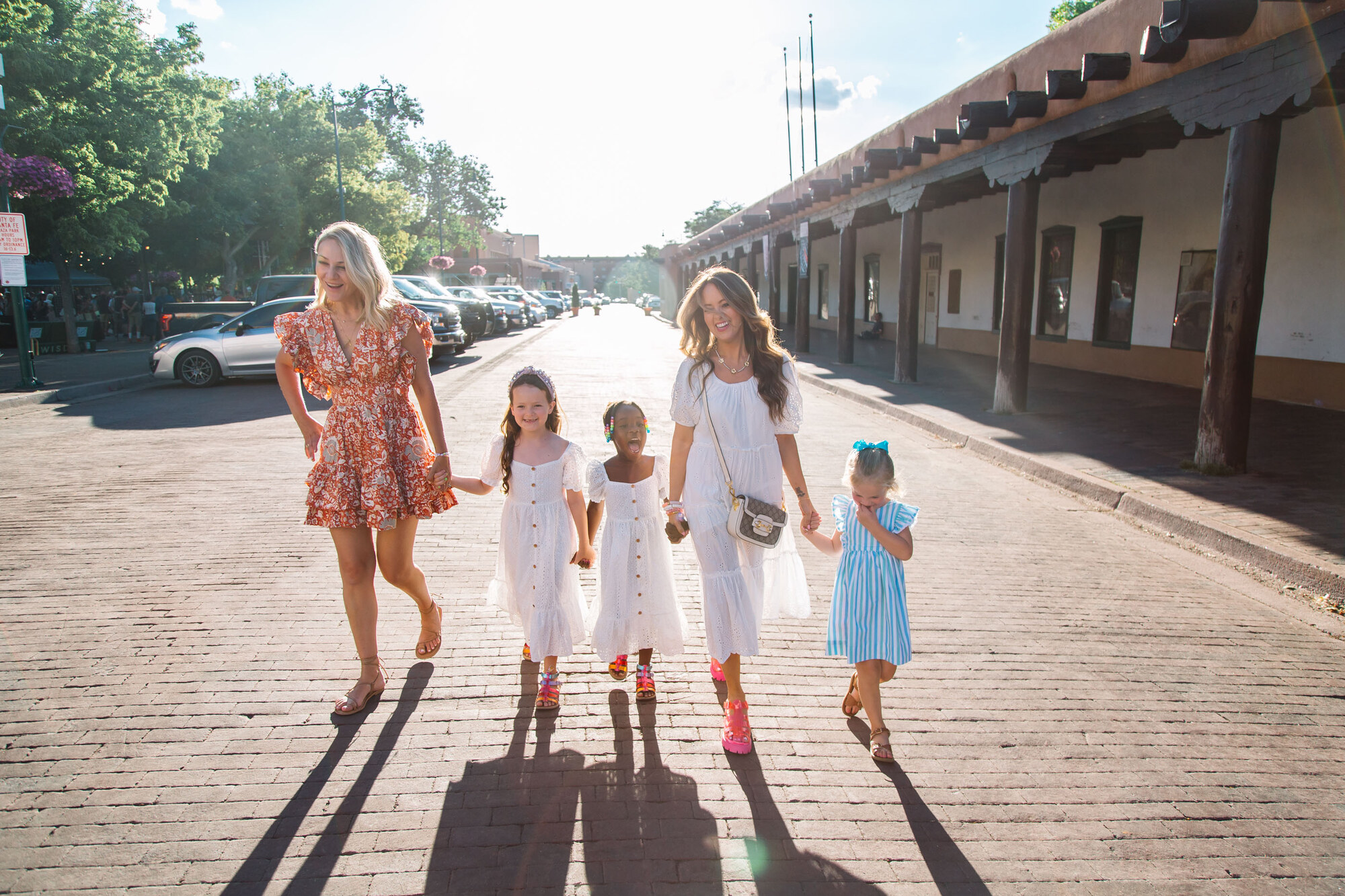 The Ice family walking the Santa Fe Plaza at golden hour